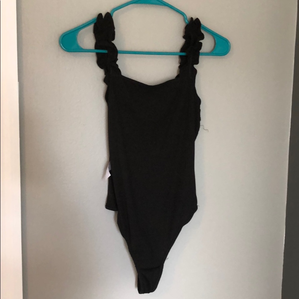 Black ruffle body suit never worn